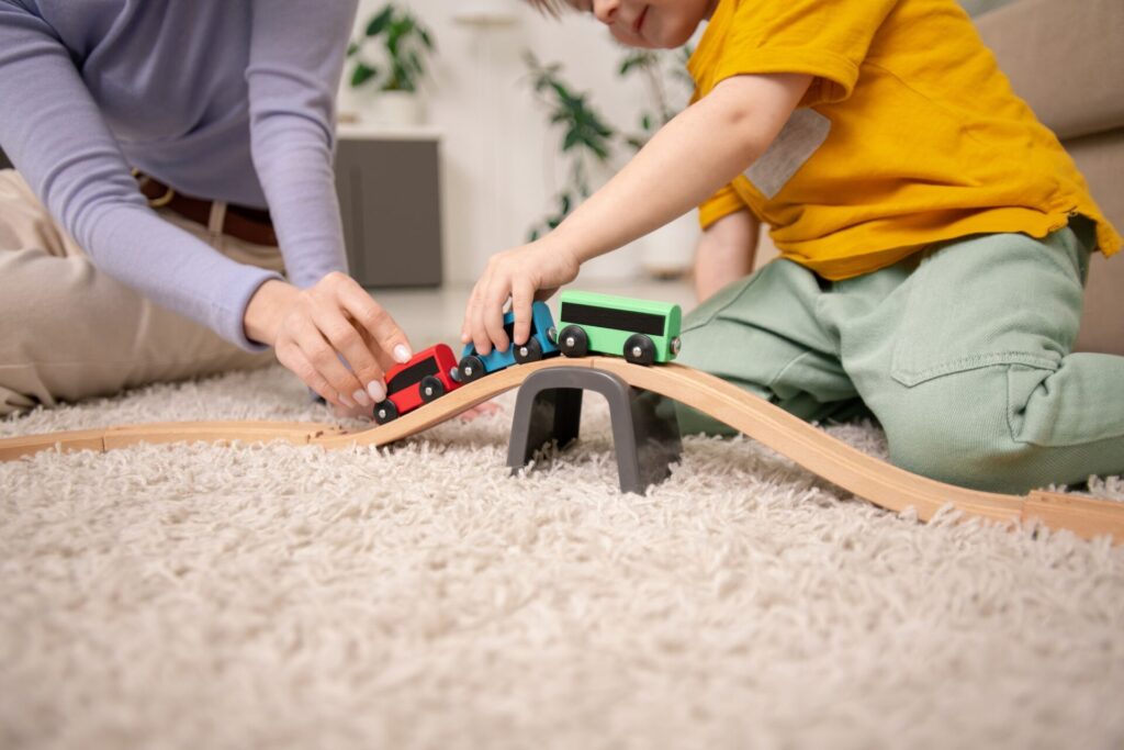 Playing with toy train on toy railway