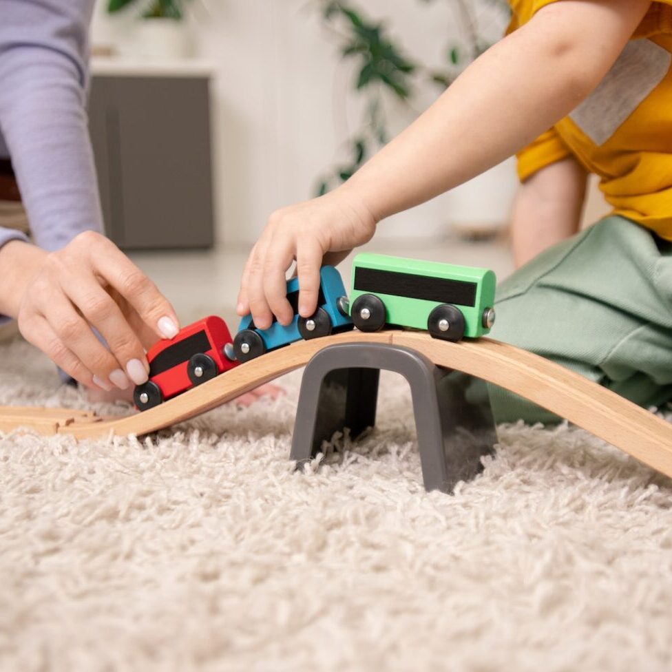 Playing with toy train on toy railway